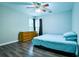 Cozy bedroom with hardwood floors, dresser, and ceiling fan at 2238 Roseberry Ln, Grayson, GA 30017