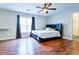 Spacious bedroom featuring wood floors, a ceiling fan, and a large window with nice natural light at 2238 Roseberry Ln, Grayson, GA 30017
