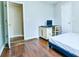 Bedroom with desk area, wood floors, and an open closet at 2238 Roseberry Ln, Grayson, GA 30017