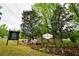 Stone community entrance sign surrounded by colorful flowers and lush landscaping at 2238 Roseberry Ln, Grayson, GA 30017