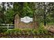 Stone sign for Pebble Creek Farm with colorful landscaping and flowers at 2238 Roseberry Ln, Grayson, GA 30017