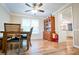 Bright dining room featuring hardwood floors, ceiling fan, and a china cabinet at 2238 Roseberry Ln, Grayson, GA 30017