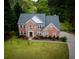 Two-story brick home with a well-manicured lawn and a paved driveway at 2238 Roseberry Ln, Grayson, GA 30017