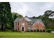 Charming brick residence with a lush green lawn, showcasing timeless design and inviting curb appeal in a residential setting at 2238 Roseberry Ln, Grayson, GA 30017