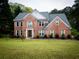 Two-story brick home with a manicured lawn and a paved walkway to the front door at 2238 Roseberry Ln, Grayson, GA 30017