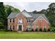 Traditional two-story brick home featuring well-manicured lawn, classic architectural detailing, and a welcoming front entrance at 2238 Roseberry Ln, Grayson, GA 30017