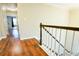 Upstairs hallway featuring gleaming wood flooring and a view into another room at 2238 Roseberry Ln, Grayson, GA 30017