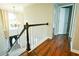 Stairway to the second floor featuring gleaming wood flooring, and white wood railing at 2238 Roseberry Ln, Grayson, GA 30017