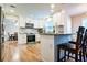 Well-lit kitchen with white cabinets, stainless appliances, and a granite countertop bar at 2238 Roseberry Ln, Grayson, GA 30017