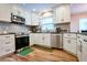 Modern kitchen features stainless steel appliances, granite countertops, and ample cabinet space at 2238 Roseberry Ln, Grayson, GA 30017