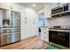 Kitchen with stainless steel fridge, white cabinets, and subway tile backsplash at 2238 Roseberry Ln, Grayson, GA 30017