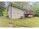 A backyard features a deck, lush green grass, an A/C unit, and a sturdy brick foundation at 2682 Cavalier Dr, Decatur, GA 30034