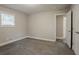 Bedroom featuring carpeted floors, neutral colors, and a closet with a door to an additional room at 2682 Cavalier Dr, Decatur, GA 30034