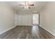 This bedroom has wood floors, a ceiling fan, closet, neutral paint and a doorway leading to another room at 2682 Cavalier Dr, Decatur, GA 30034