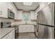 Bright kitchen with stainless steel appliances, white cabinetry, subway tile backsplash, and gray countertops at 2682 Cavalier Dr, Decatur, GA 30034
