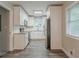 Modern kitchen featuring white cabinets, stainless steel appliances, granite countertops, and wood-look flooring at 2682 Cavalier Dr, Decatur, GA 30034