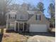 Charming two-story home featuring neutral siding, black shutters, and an attached two-car garage at 3967 Moos Creek Ct, Loganville, GA 30052