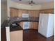 Functional kitchen with white appliances, granite countertops, and wood cabinets at 3967 Moos Creek Ct, Loganville, GA 30052