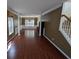 Open-concept living room with hardwood floors, columns, and large windows at 3967 Moos Creek Ct, Loganville, GA 30052