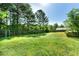 A large backyard bordered by mature trees and fencing offers a private outdoor space for recreation and relaxation at 7194 Oakwood Cir, Rex, GA 30273
