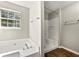 Bathroom featuring a separate bathtub and shower, wood-look floors, and bright lighting at 7194 Oakwood Cir, Rex, GA 30273