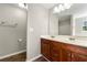 Bathroom featuring double sinks, wood-look floors, and neutral walls and ample counter space at 7194 Oakwood Cir, Rex, GA 30273