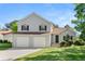 Charming two-story home featuring a two-car garage and well-manicured front lawn at 7194 Oakwood Cir, Rex, GA 30273