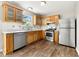 Well-lit kitchen featuring wooden cabinets, stainless steel appliances, and a window overlooking the yard at 7194 Oakwood Cir, Rex, GA 30273