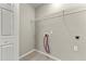 Laundry room with tile floors, wire shelving, fresh paint, and hookups for a washer and dryer at 7194 Oakwood Cir, Rex, GA 30273