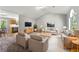 Spacious living room with neutral tones, comfortable seating, and a view into the kitchen at 7194 Oakwood Cir, Rex, GA 30273