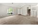 Spacious living room featuring high ceilings, a large window, and staircase at 7194 Oakwood Cir, Rex, GA 30273