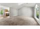 Open concept living room with view into kitchen, hardwood floor, and natural light at 7194 Oakwood Cir, Rex, GA 30273