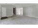 Large living room with neutral carpet and paint, plenty of space, and open access to stairs at 7194 Oakwood Cir, Rex, GA 30273