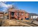Back exterior of a brick house with a staircase and a grassy yard at 958 Winburn Dr, Atlanta, GA 30344