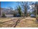 Large backyard featuring a garage and vehicles parked on a grassy yard at 958 Winburn Dr, Atlanta, GA 30344