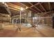 Unfinished basement features exposed utilities, brick walls, and a concrete floor at 958 Winburn Dr, Atlanta, GA 30344