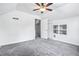 A bright bedroom with slanted ceiling, a ceiling fan, neutral carpet, and built-ins at 958 Winburn Dr, Atlanta, GA 30344