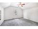A bright bedroom with slanted ceiling, a ceiling fan, and neutral carpet at 958 Winburn Dr, Atlanta, GA 30344