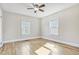 Bright bedroom featuring hardwood floors, two windows, and a ceiling fan at 958 Winburn Dr, Atlanta, GA 30344