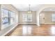 Bright dining room featuring large windows, modern lighting and hardwood floors at 958 Winburn Dr, Atlanta, GA 30344