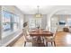 Staged dining room with large windows, modern lighting, and hardwood floors at 958 Winburn Dr, Atlanta, GA 30344