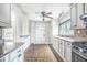 Bright kitchen features white cabinets, stainless steel appliances, and tiled flooring for a modern look at 958 Winburn Dr, Atlanta, GA 30344