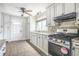 Modern kitchen with stainless steel gas range, tile backsplash, and white cabinets at 958 Winburn Dr, Atlanta, GA 30344