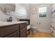 Modern bathroom featuring shiplap walls, a sleek vanity, and a round mirror, offering a fresh and stylish space at 415 Eldridge Dr, Suwanee, GA 30024