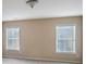 A neutral bedroom featuring two windows with blinds for a bright and airy feel at 415 Eldridge Dr, Suwanee, GA 30024