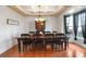 Formal dining room with coffered ceiling, chandelier, and large window providing ample natural light at 415 Eldridge Dr, Suwanee, GA 30024
