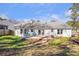 View of the home's back exterior featuring a large yard, deck and white siding at 4247 Windward Ln, Norcross, GA 30093