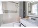 This bathroom includes a shower-tub combo and white vanity with storage at 4247 Windward Ln, Norcross, GA 30093