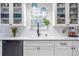 Well-organized kitchen features modern finishes, marble countertops, and white cabinets at 4247 Windward Ln, Norcross, GA 30093