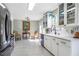 Bright kitchen featuring white cabinets, stylish lighting and stainless steel appliances at 4247 Windward Ln, Norcross, GA 30093
